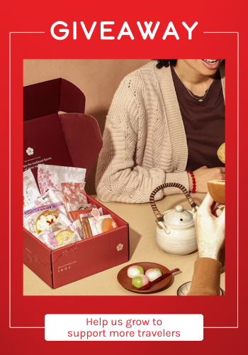 Two people enjoy tea with sweets beside a gift box filled with Japanese treats. Text above reads "GIVEAWAY," and below, "Help us grow to support more travelers."