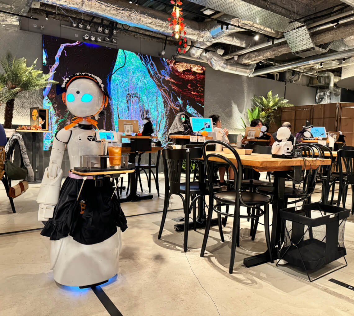 Interior of DAWN Avatar Robot Cafe in Tokyo, featuring robots serving customers, showcasing accessibility and inclusivity for people with disabilities